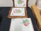 a picture of a table with a mirror and a picture of flowers on it