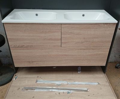 a picture of a bathroom with two sinks and a wooden floor