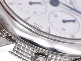 a close up of a silver watch with a blue second hand