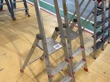 many ladders that are sitting on the floor in the room