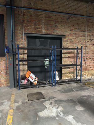 a parking lot with a parking meter in front of a brick building