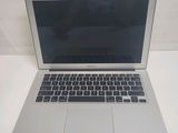 an open laptop computer sitting on top of a white table