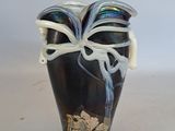 a black vase with a white ribbon on it