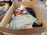 a cardboard box filled with clothes in a store