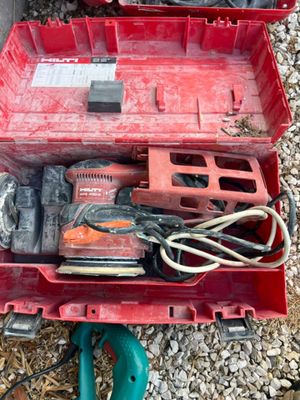 a red tool box with tools in it on the ground