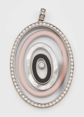 a close up of a pendant with a black and white circle