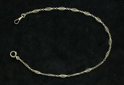 a silver bracelet with a chain and a clasp on a black background