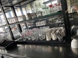 many glasses and cups on the counter in the kitchen