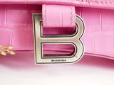 the pink bag has a metal letter b on it