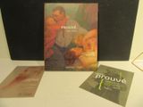une photo représentant un livre et deux livres posés sur une table