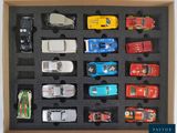many toy cars in a box on a table