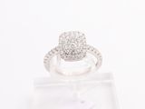 a close up of a diamond ring on a clear display stand