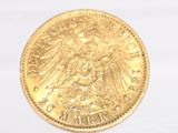 a gold coin with a eagle on it on a white surface
