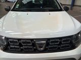 the front of a white car parked in a parking lot