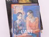 two books on a table with a painting of two people on the cover