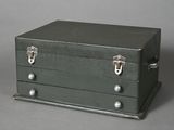 a small metal box with three drawers on it