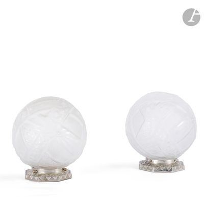 three white glass lamps on a metal stand on a white surface