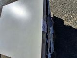 a pile of papers sitting on the ground next to a trash can