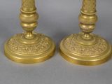pair of antique brass candlesticks with ornate designs on bases