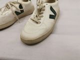 a pair of shoes that are on a bed