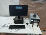 a desk with a computer, keyboard, mouse, and other electronics on it
