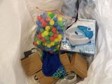a bag of assorted items sitting on a bed
