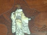 a picture of a statue of a woman on top of a table