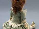 an image of a doll that is sitting on the ground