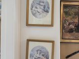 three framed pictures on the wall of a room