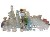 a lot of glass bottles and glasses sitting on a table