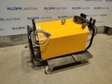 une machine jaune posée sur une palette devant un mur