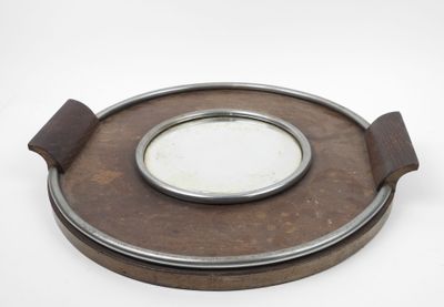 a small round mirror sitting on top of a wooden plate