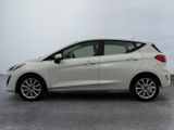 the white car is parked on the concrete floor in the parking lot