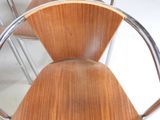 a wooden chair that has a metal frame around it