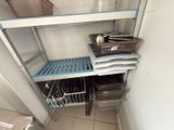a shelf that has some pots and pans on it