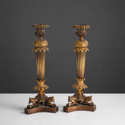 pair of antique brass candlesticks on wooden bases