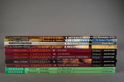 many books stacked on top of each other on a table