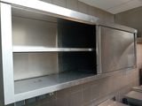 a metal shelf in the middle of a kitchen