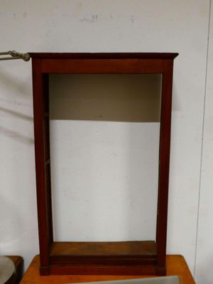 a small wooden box with a mirror on top of it