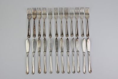 a lot of forks and spoons that are on the table