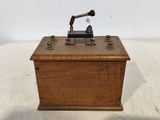 a small wooden box with a radio on top of it