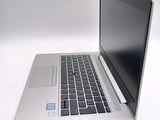 a laptop that is sitting on a white surface