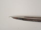 a close up of a pen on a white surface