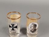 two shot glasses with a picture of a man on them