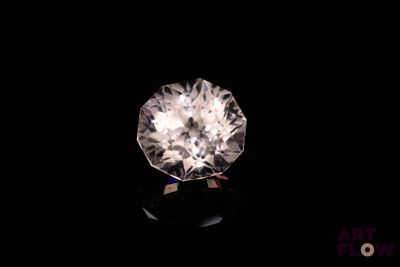 a close up of a white diamond on a black surface