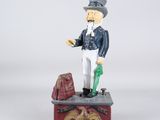 figurine of a man in a military uniform standing on a box