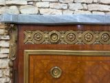 a marble top on a wooden chest of drawers