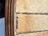 a close up of a wooden table with a clock on it