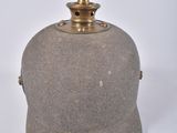 a small stone vase with a metal lid