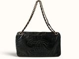 a chanel black leather shoulder bag with a chain strap
